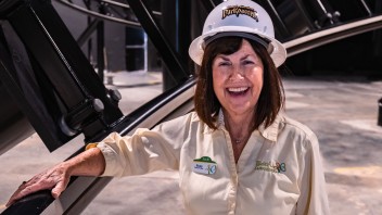 Suzy Cheely in hard hat next to coaster track, courtesy