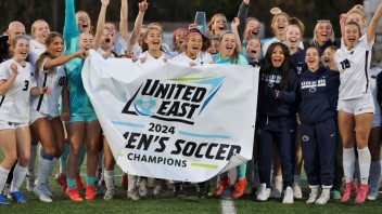 photo of Penn State Harrisburg soccer team holding up a banner, photo by Penn State Harrisburg
