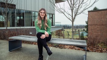 Avery Volz seated on a bench outside a Penn State York building, photo by Cardoni