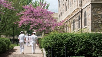 men in Navy uniforms walking on campus in spring time photo by Corinne Furjanic