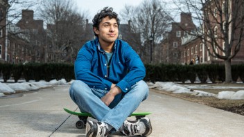 George Kadavil seated on sidewalk, photo by Cardoni