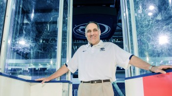 photo of Joe Battista standing at interior Pegula rink entrance by Cardoni