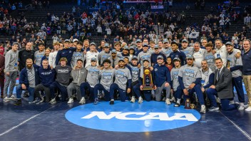 group shot of Penn State wrestling team after setting another NCAA championship record, by Mark Selders/Penn State Athletics