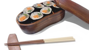 photo of a wooden lunch box with sushi and chopsticks, courtesy