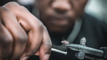 closeup of hands tying a fly fishing lure courtesy George Daniels