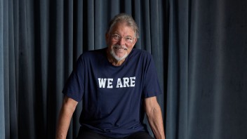 photo of Jonathan Frakes wearing a blue We Are t-shirt and sitting on a theater prop box by Gregg Segal