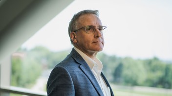 Andrew Read standing by window by Cardoni