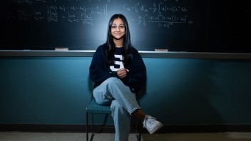 photo of Divya Tyago seated in front of a chalkboard by Cardoni