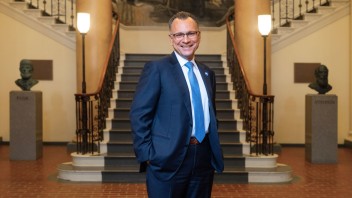 Fotis Sotiropoulos standing before large staircase in Old Main, photo by Michael Owen/Penn State
