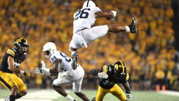 Barkley jumping over Iowa defender, photo by Steve Manuel ’84 Lib, ’92 MA Com