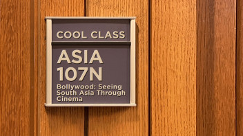 blue classroom sign that reads ASIA 107N