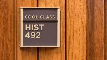 blue classroom sign that reads HIST 492