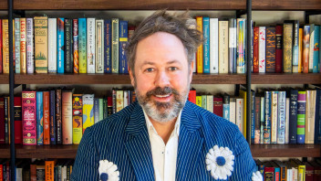 photo of Jeremy Engels seated in front of a bookshelf, courtesy