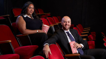 photo of two Hollywood Program alums seated in a theater of red seats by Gregg Sega
