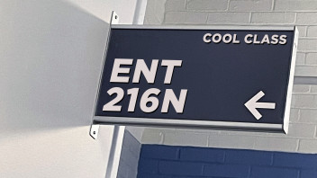 blue classroom sign that reads ENT 216N